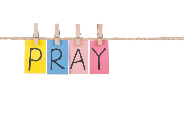 Pray, Colorful words hang on rope by wooden peg - Foto, afbeelding