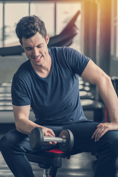 Lifestyle playful man having fun Lifting dumbbell in gym exercis - Photo, Image