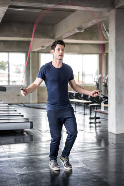 Handsome man training with his skipping rope best cardio workout - 写真・画像