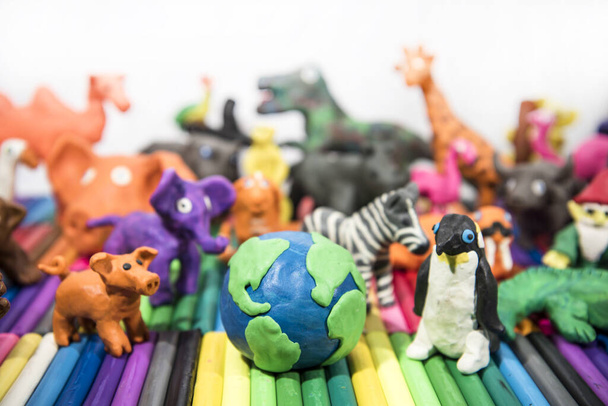 Animals made from Play Clay with Earth Planet in middle. - 写真・画像