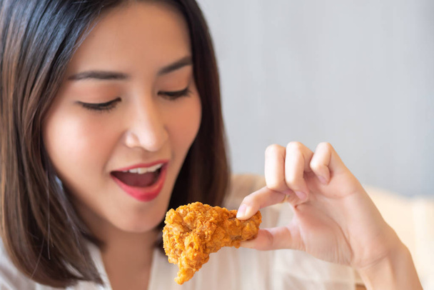 hungry woman looking, eating fried chicken, concept of delicious food, health care, eating habit, yummy fried chicken - Foto, imagen
