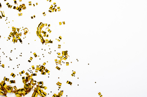 Golden confetti on a white background. The concept of a holiday, party, birthday, decoration. Banner Flat lay, top view - Fotoğraf, Görsel