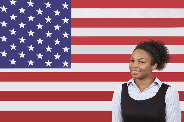Businesswoman smiling over American flag - Zdjęcie, obraz