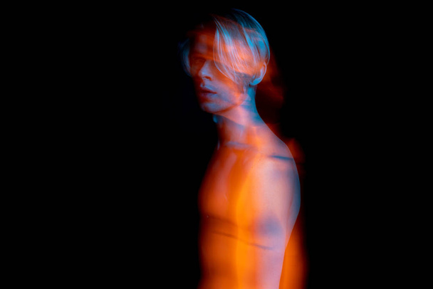 artistic long exposure portrait of naked torso young man. complimentary colors teal orange. representation of subconscious fears or feelings - Photo, Image