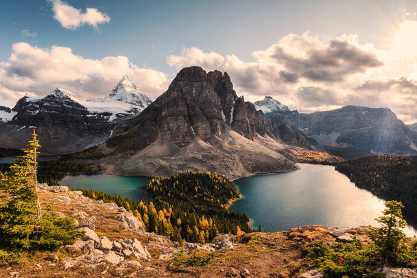 Mount Assiniboine with Sunburst and Cerulean lake in autumn pine - Photo, image