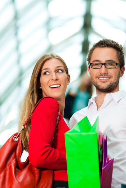 man and woman in department store with bags - Photo, Image