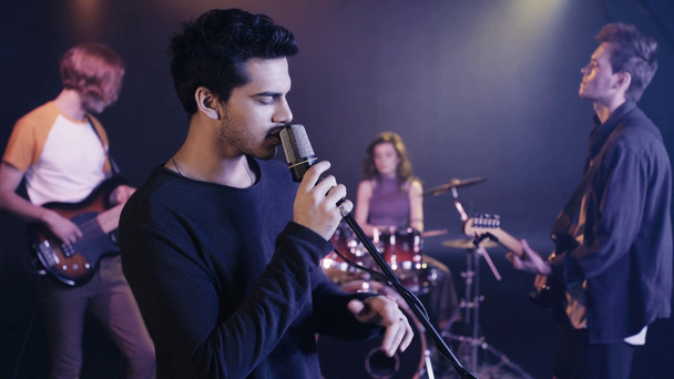 selective focus of singer performing with rock band  - Footage, Video