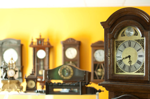 Old antique clocks close up and blurred background clocks - 写真・画像