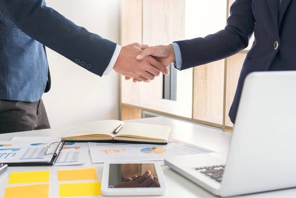 Good deal career and placement concept, successful young businessmen shaking hands after successful negotiation in modern office. - Photo, Image