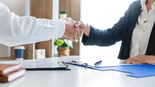 Good deal career and placement concept, successful young businessmen shaking hands after successful negotiation in modern office. - Photo, image