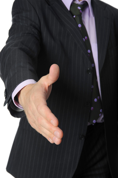 Businessman in a suit holds out his hand for a handshake. - Photo, Image