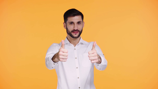 excited man showing thumbs up isolated on orange - Filmati, video