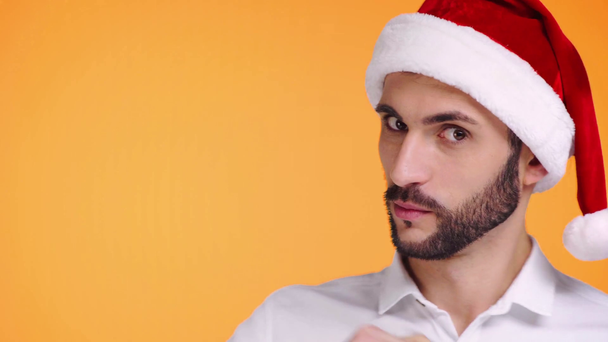 bearded man in santa hat pointing with fingers isolated on orange  - Filmmaterial, Video