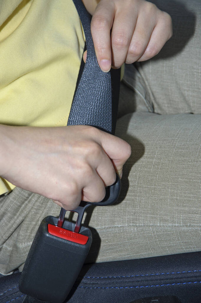 Woman fastening her seat belt in a car  - Φωτογραφία, εικόνα