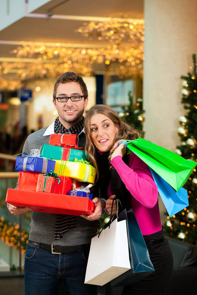 couple at christmas in department store shopping - Фото, изображение