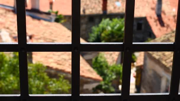 Observing freedom, nature, villages, summer day through jail (jail-like) window, through mighty iron forged (prison) gratings, old castle - Video