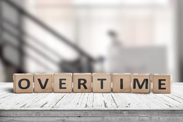 Overtime word spelled with wooden blocks - Foto, imagen