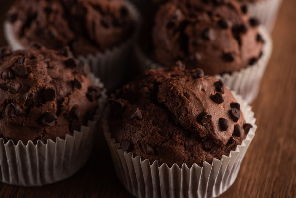close up view of fresh chocolate muffins on wooden surface - Φωτογραφία, εικόνα