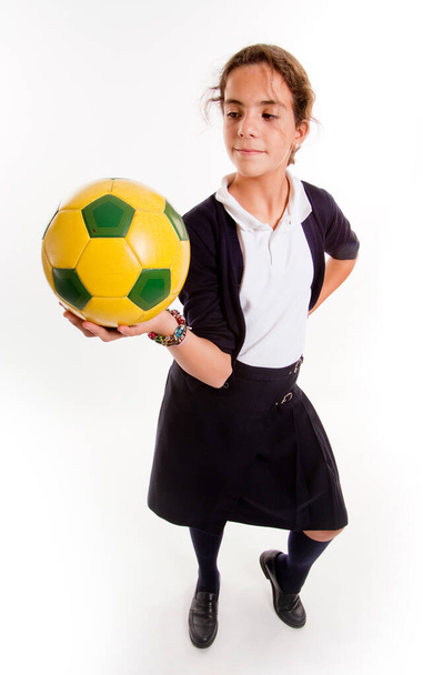 Schoolgirl in uniform with a soccer ball - Foto, Imagen
