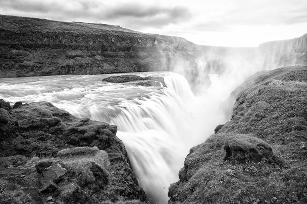 Canyon beauty. Waterfall located in canyon river Iceland. River rapid waterfall. Water beautiful stream flow. Nature landscape. Iceland tourist destinations concept. Waterfall in Iceland. Wet air - Фото, изображение