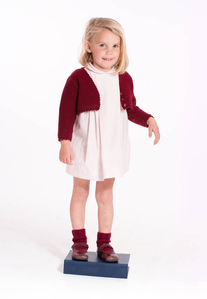 little adorable girl in stylish clothe, posing on camera - Фото, изображение