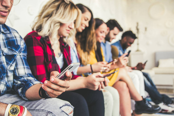 Close up of group of young people with smartphones in the hands. - Photo, Image