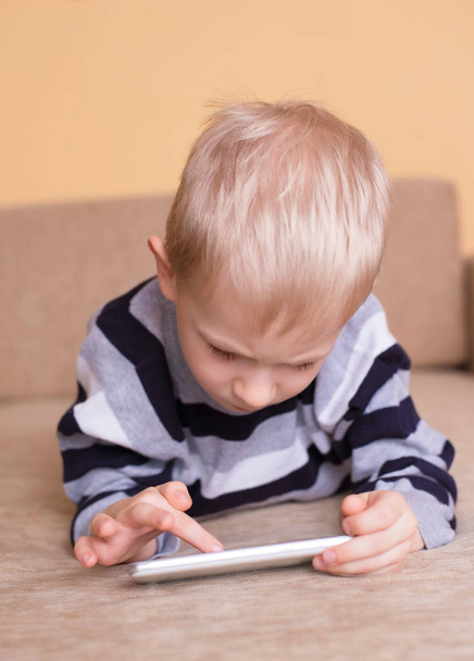 Young blond child use smartphone - Photo, image