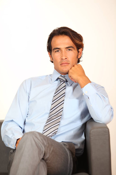 Portrait of businessman sitting in armchair - Fotografie, Obrázek