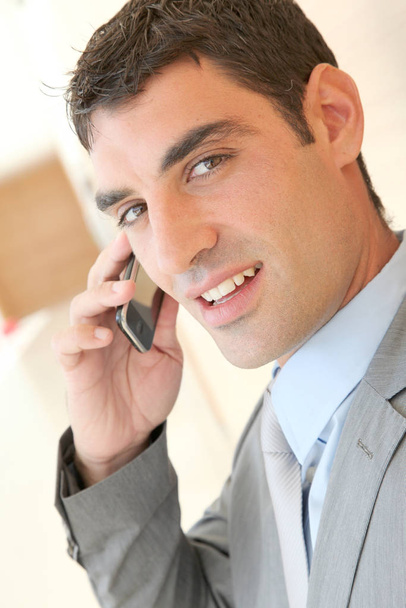Portrait of salesman talking on the phone - 写真・画像