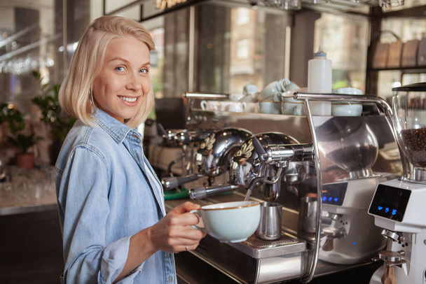 Charming female barista working at local coffee shop - Photo, Image