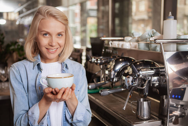 Charming female barista working at local coffee shop - Foto, Bild