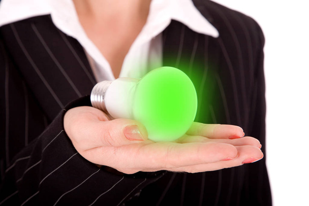 Business person showing lighting bulb in hands. - Photo, image