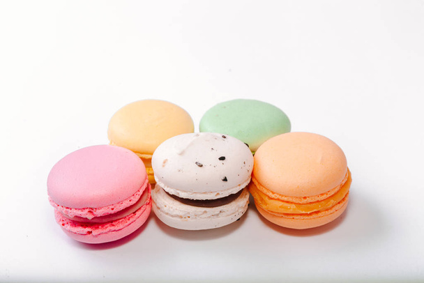 French colorful macarons background,Colorful macarons on white background. Macaron or Macaroon is sweet meringue-based confection. Flat lay - Photo, Image