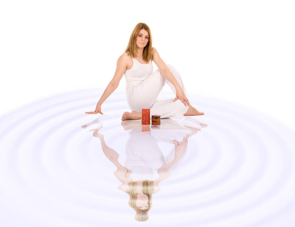 Beautiful girl in yoga pose over water reflection. - 写真・画像