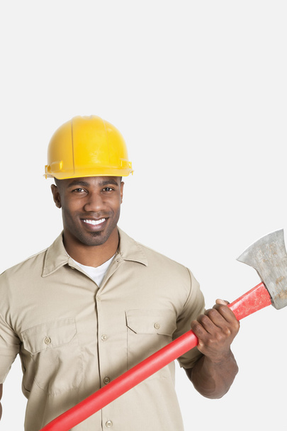 African male construction worker holding axe - Foto, afbeelding