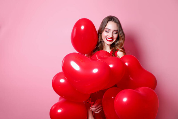 Valentine beauty girl with red heart air balloon portrait on pink background. Birthday party, . - Фото, зображення