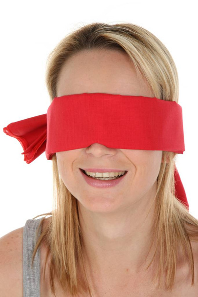 Pretty young blonde lady with a red blindfold over her eyes - Zdjęcie, obraz