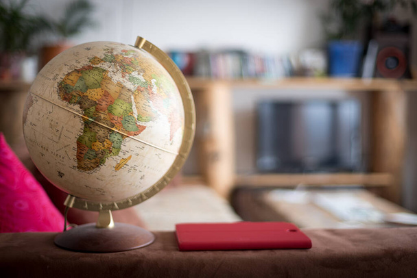 Planning the next journey: Globe in the living room, nobody - Valokuva, kuva
