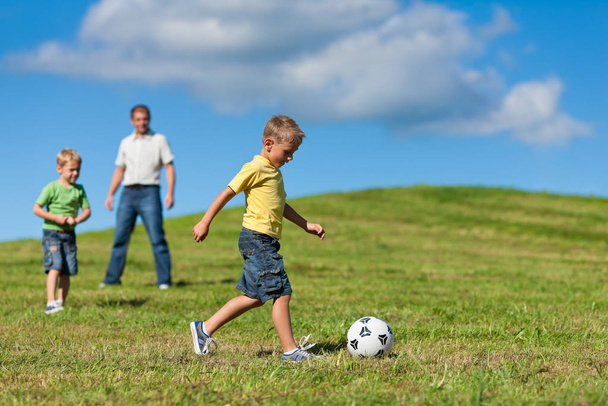 happy family is playing soccer in summer - Φωτογραφία, εικόνα
