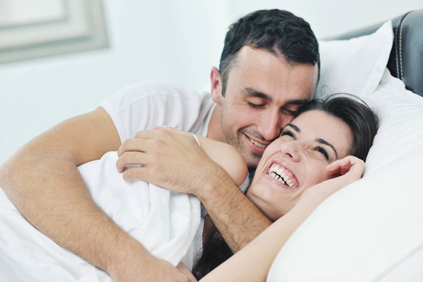 happy young healthy people  couple have good time in their bedroom make love and sleep - 写真・画像