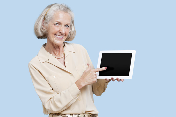 Senior woman showing tablet PC - Photo, Image