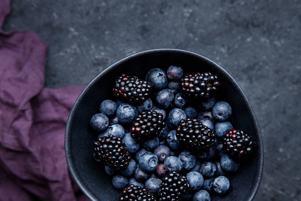 Fresh summer berries in bowl close up. - Фото, зображення