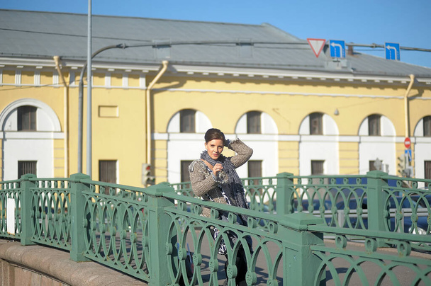 woman in a gray sweater on a bridge - Fotó, kép