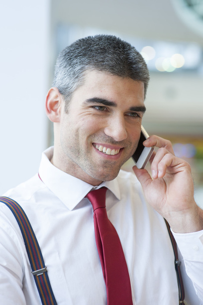 Businessman smiling on mobile phone - Foto, imagen