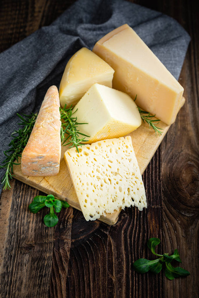 Cheeses with basil and rosemary. - Фото, изображение
