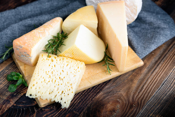 Cheeses with basil and rosemary. - Photo, Image