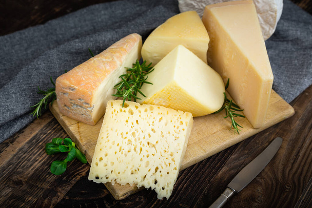Cheeses with basil and rosemary. - Photo, Image