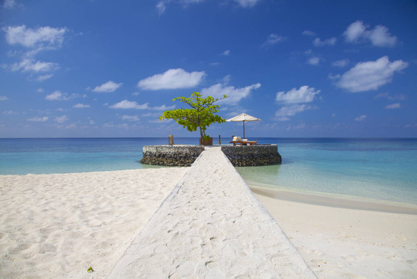 deck chair under an umbrella on one of the islands in the Maldiv - Photo, Image