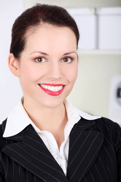 Closeup on pretty caucasian smiling businesswoman`s face. - Fotó, kép