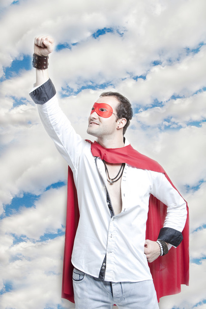 Man in superhero costume with hand raised - Photo, image